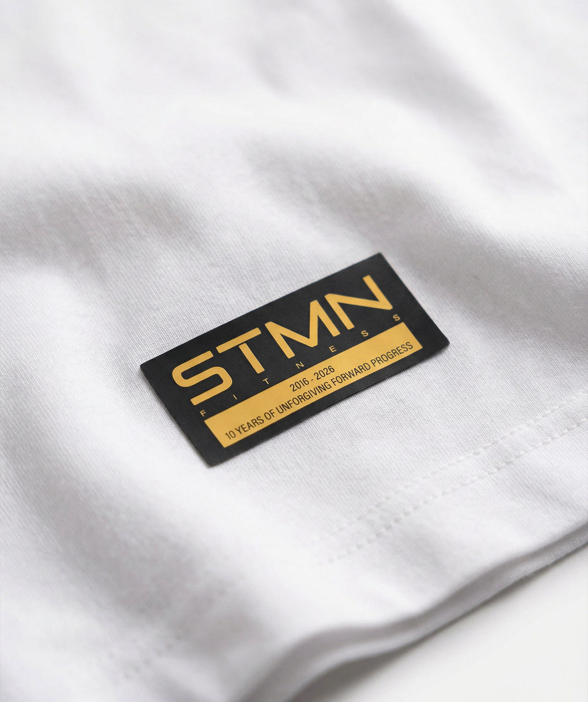 PRE-ORDER "10TH ANNIVERSARY" Loose-Fit Tee Ivory / Orange Unisex - STMN Fitness
